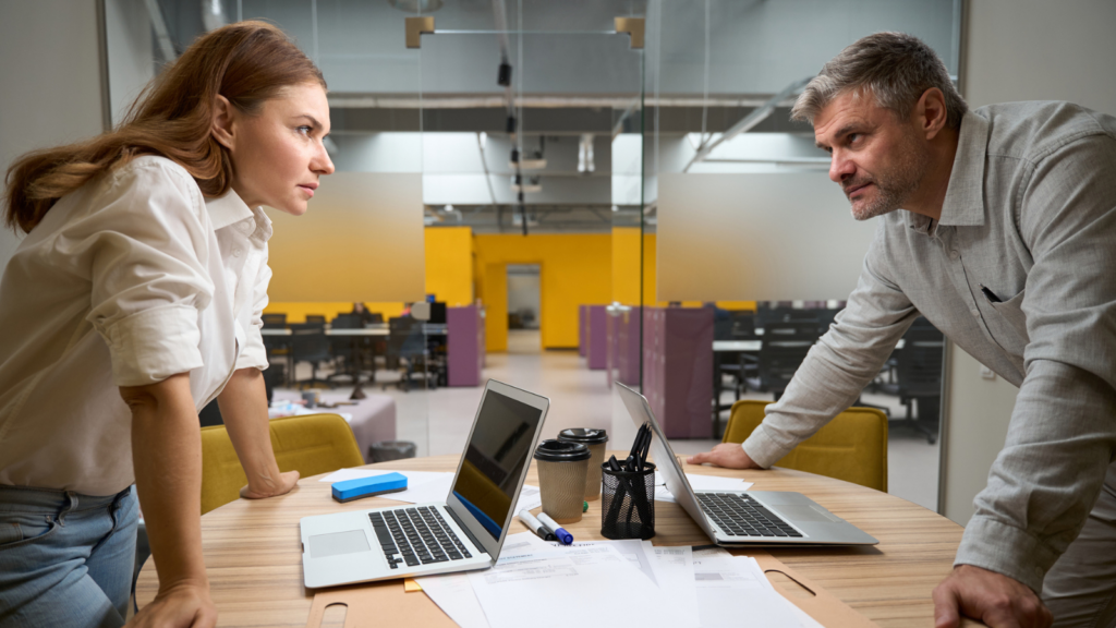 Photo of male and female teacher in a tense conversation about are women teachers treated worse