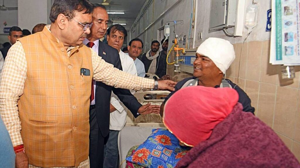 Rajasthan CM Bhajanlal Sharma interacts with a patient during a surprise inspection at Sawai Mansingh Hospital in Jaipur