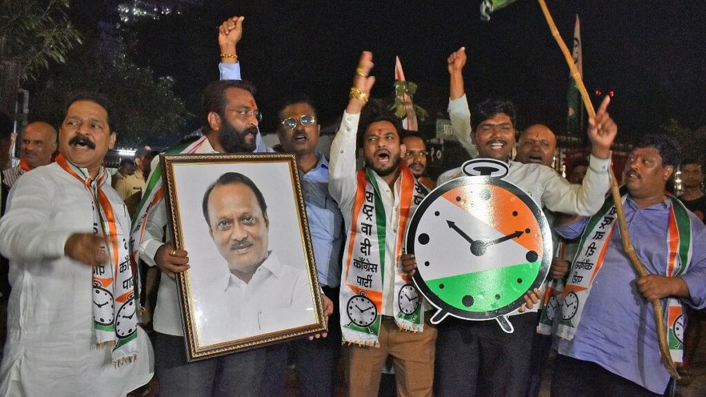 Supporters of the Ajit Pawar faction of the NCP celebrate after the Election Commission gave the faction the party’s name and symbol Tuesday