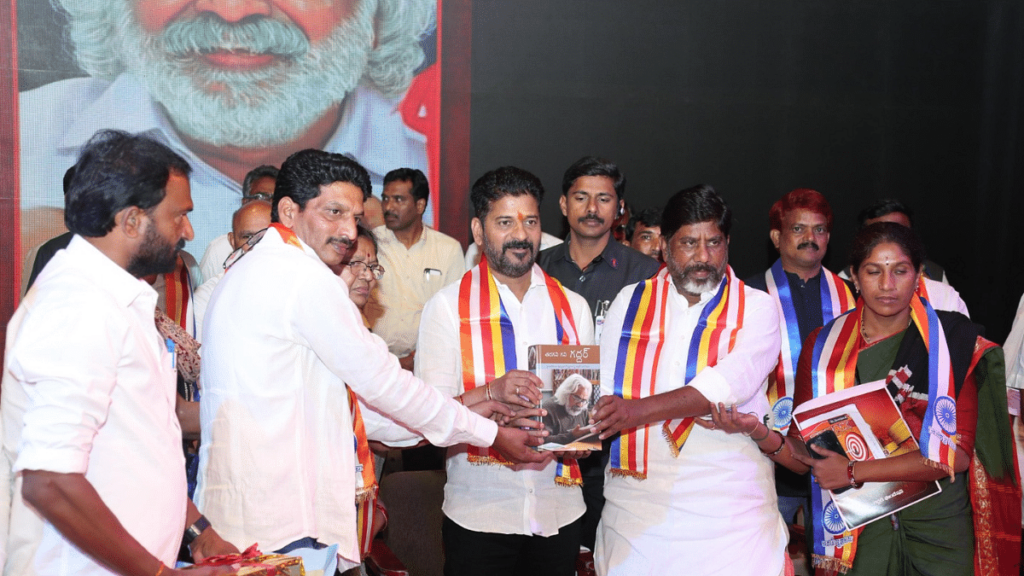 Telangana Chief Minister Revanth Reddy (centre) releases a book on renowned folk singer and balladeer Gaddar at a function, in Hyderabad on Wednesday