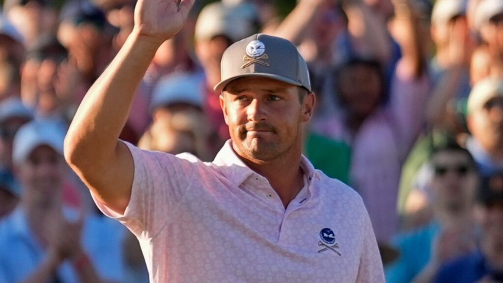 Bryson DeChambeau celebrates after chipping in for a birdie on the 18th hole during third round at the Masters golf tournament at Augusta National Golf Club Saturday, April 13, 2024, in Augusta, Ga. (AP Photo/Ashley Landis)